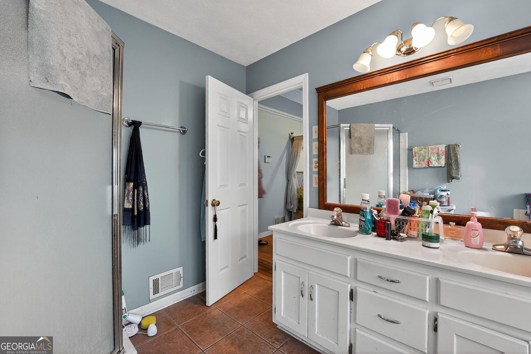 401 The Farm Road McDonough, GA 30252 - Photo 11 of 29 a bathroom with sink and mirror