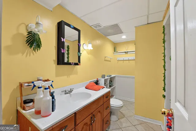 a bathroom with a sink vanity and a mirror