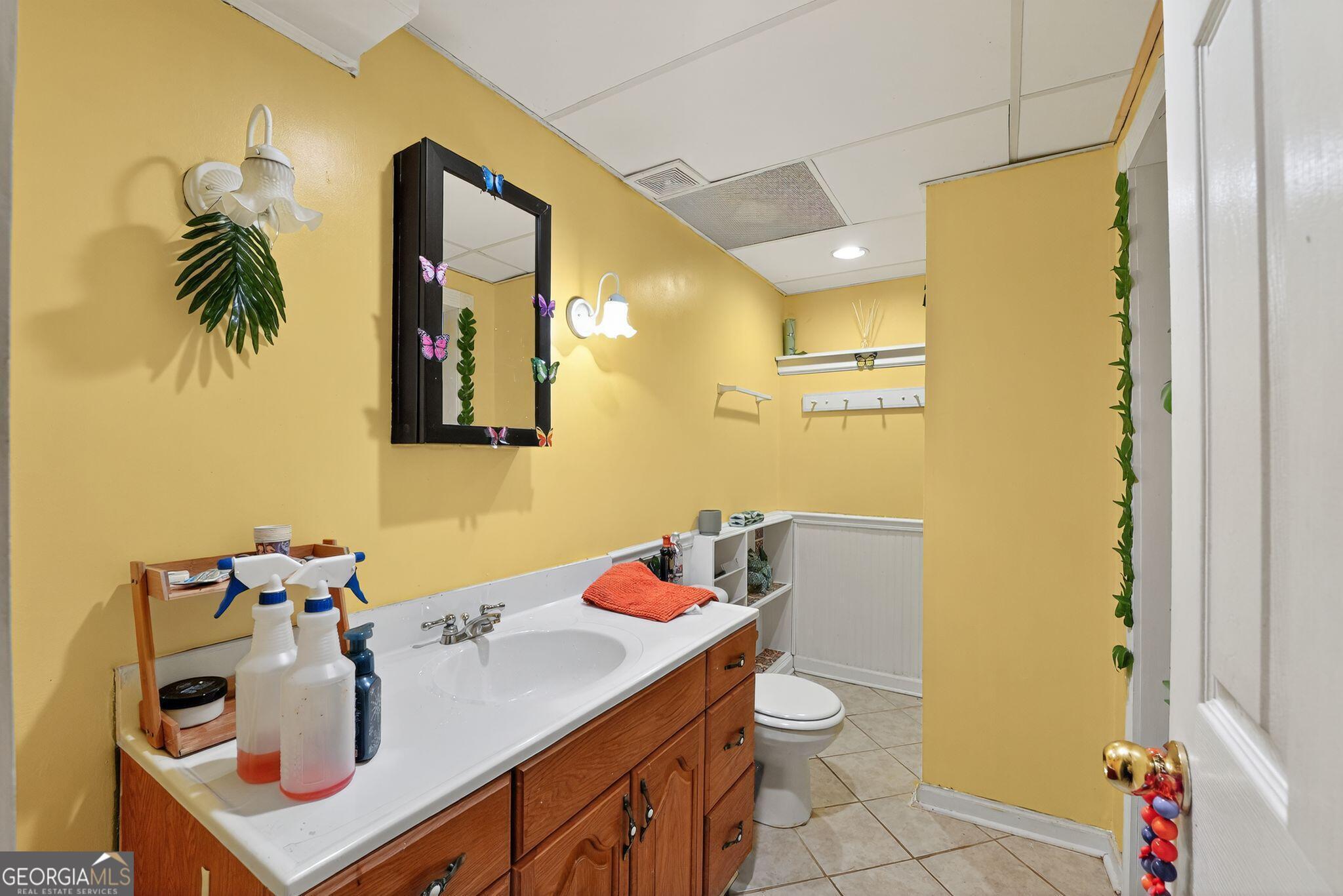 401 The Farm Road McDonough, GA 30252 - Photo 15 of 29 a bathroom with a sink vanity and a mirror