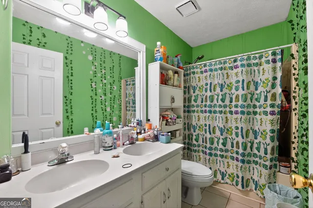 a bathroom with a sink vanity mirror and toilet