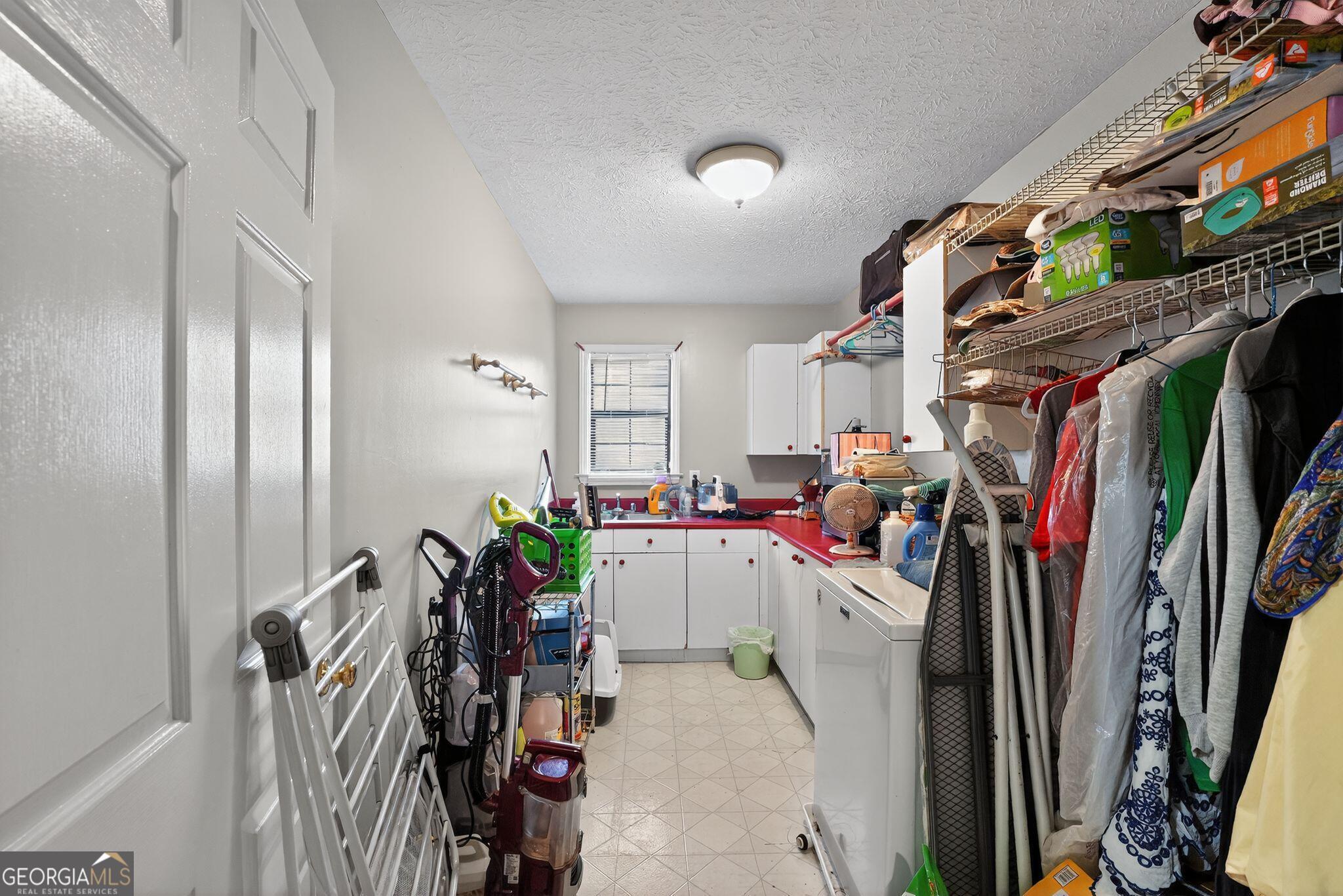 401 The Farm Road McDonough, GA 30252 - Photo 21 of 29 a view of walk in closet with clothes