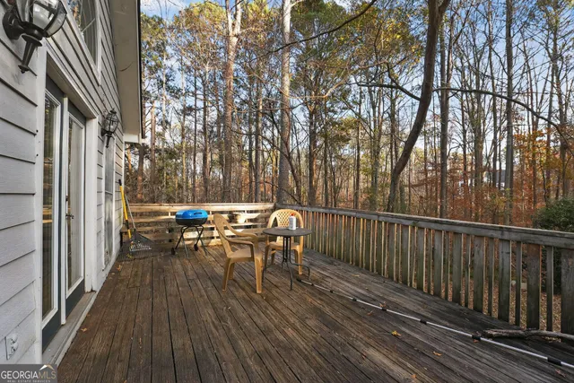a view of balcony with wooden floor and outdoor seating