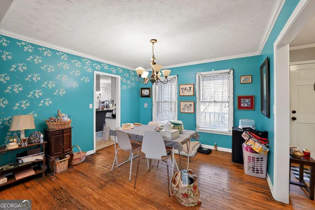 a view of a dining room with furniture and wooden floor