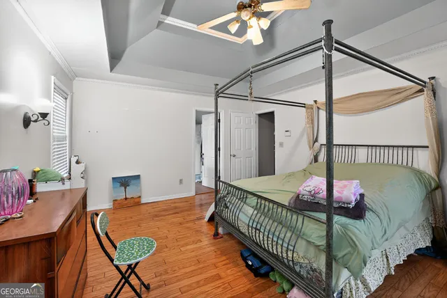 a bedroom with a bed window and a chandelier