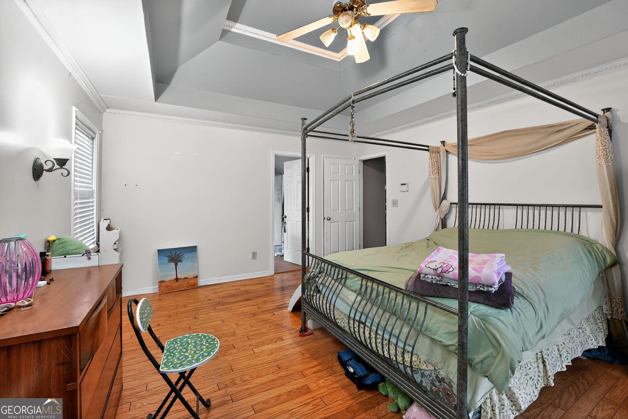 401 The Farm Road McDonough, GA 30252 - Photo 9 of 29 a bedroom with a bed window and a chandelier