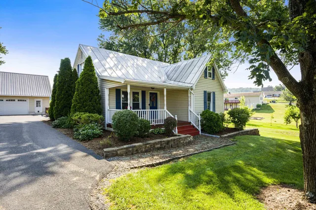 a view of a house with a yard and tree s