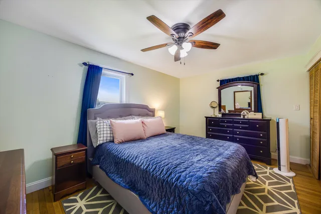 a view of living room filled with furniture and a book shelf