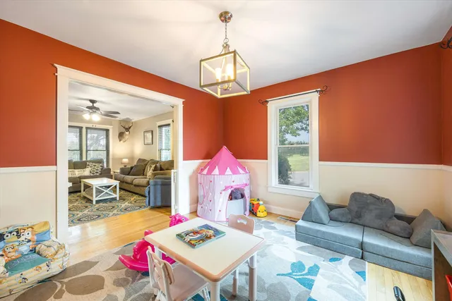 a living room with a bed and large window