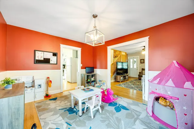 a dining table chair and a refrigerator in a kitchen