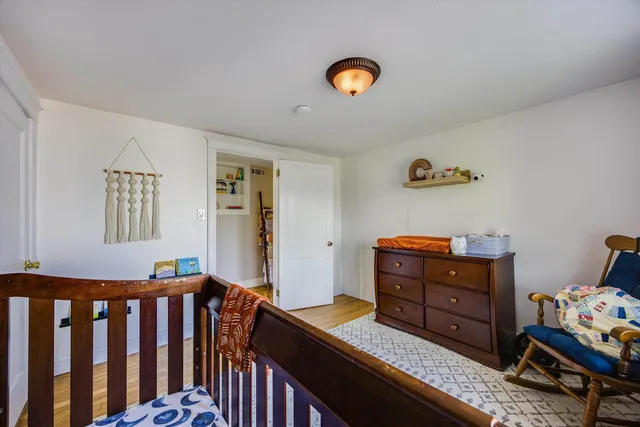 a view of a house with wooden deck and furniture