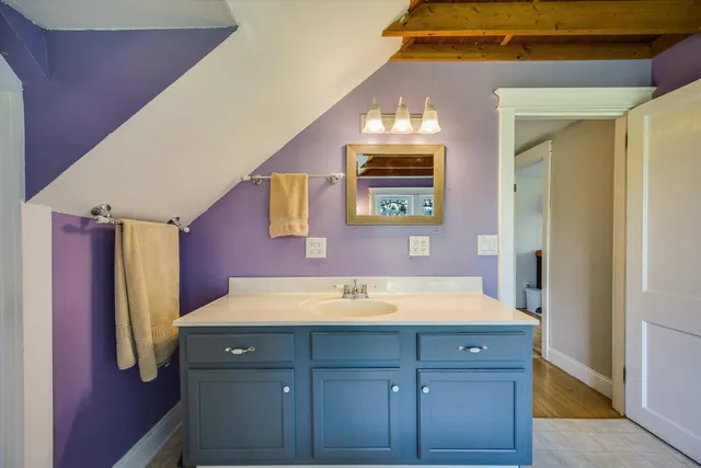 a view of a house with a big yard and large trees