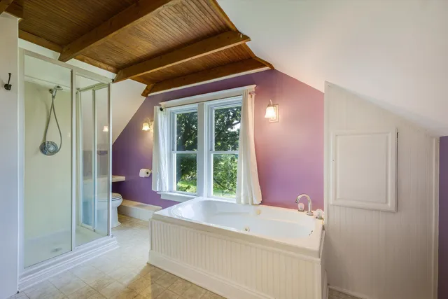 a view of a house with a backyard and a tree