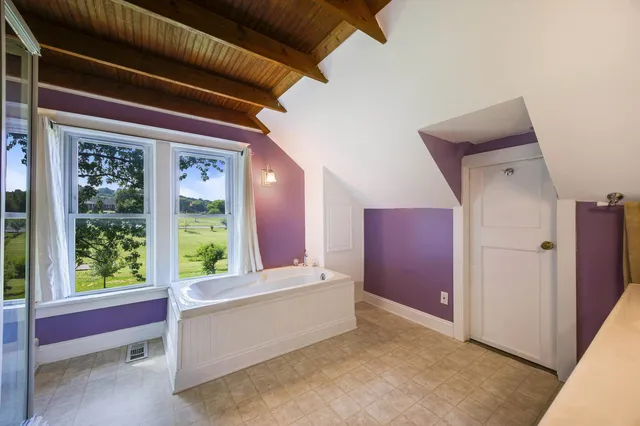 a view of a porch with furniture and wooden floor