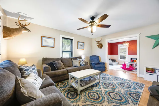 a living room with furniture and a chandelier