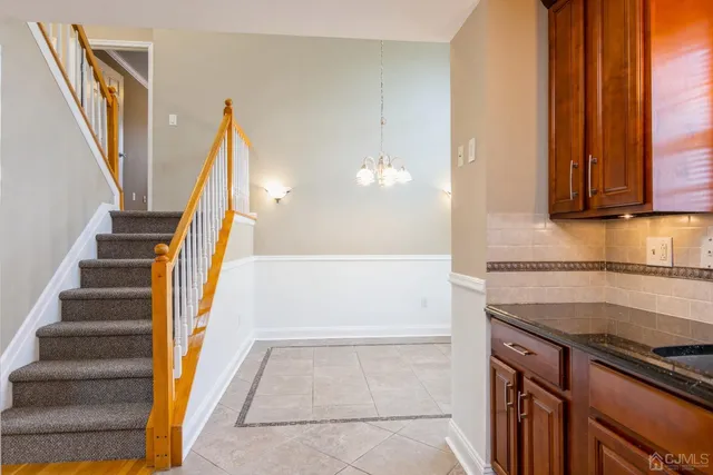 a view of a kitchen with staircase and door