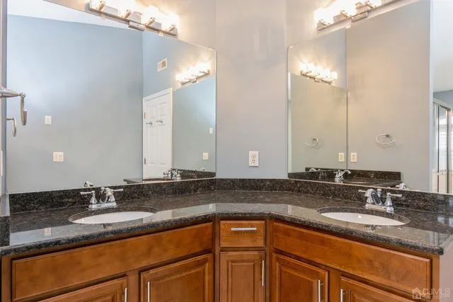 a bathroom with a sink double vanity and a mirror