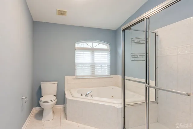 a bathroom with a toilet tub shower and a sink