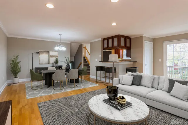 a living room with fireplace furniture and a rug