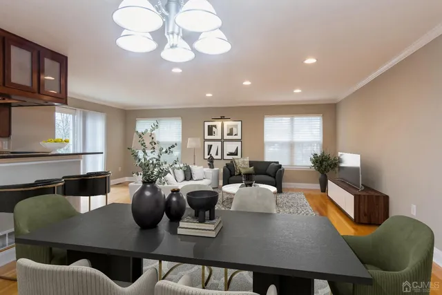 a living room with furniture kitchen view and a large window