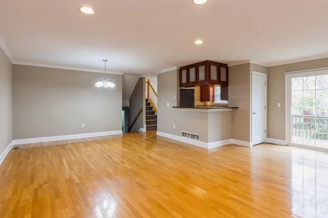 a view of a kitchen with a sink and wooden floor