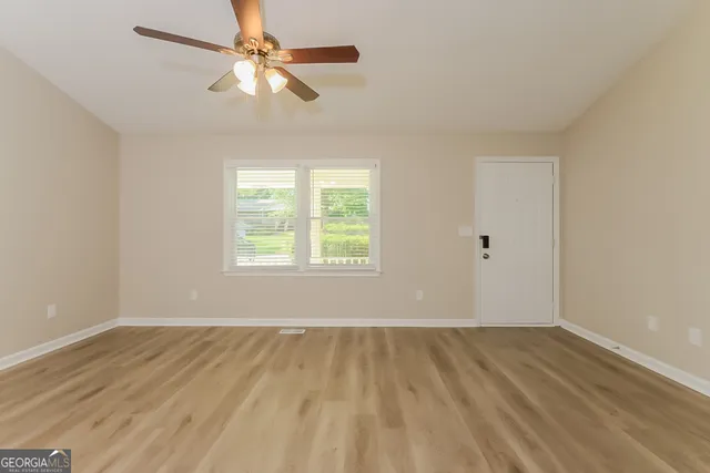wooden floor in an empty room with a window