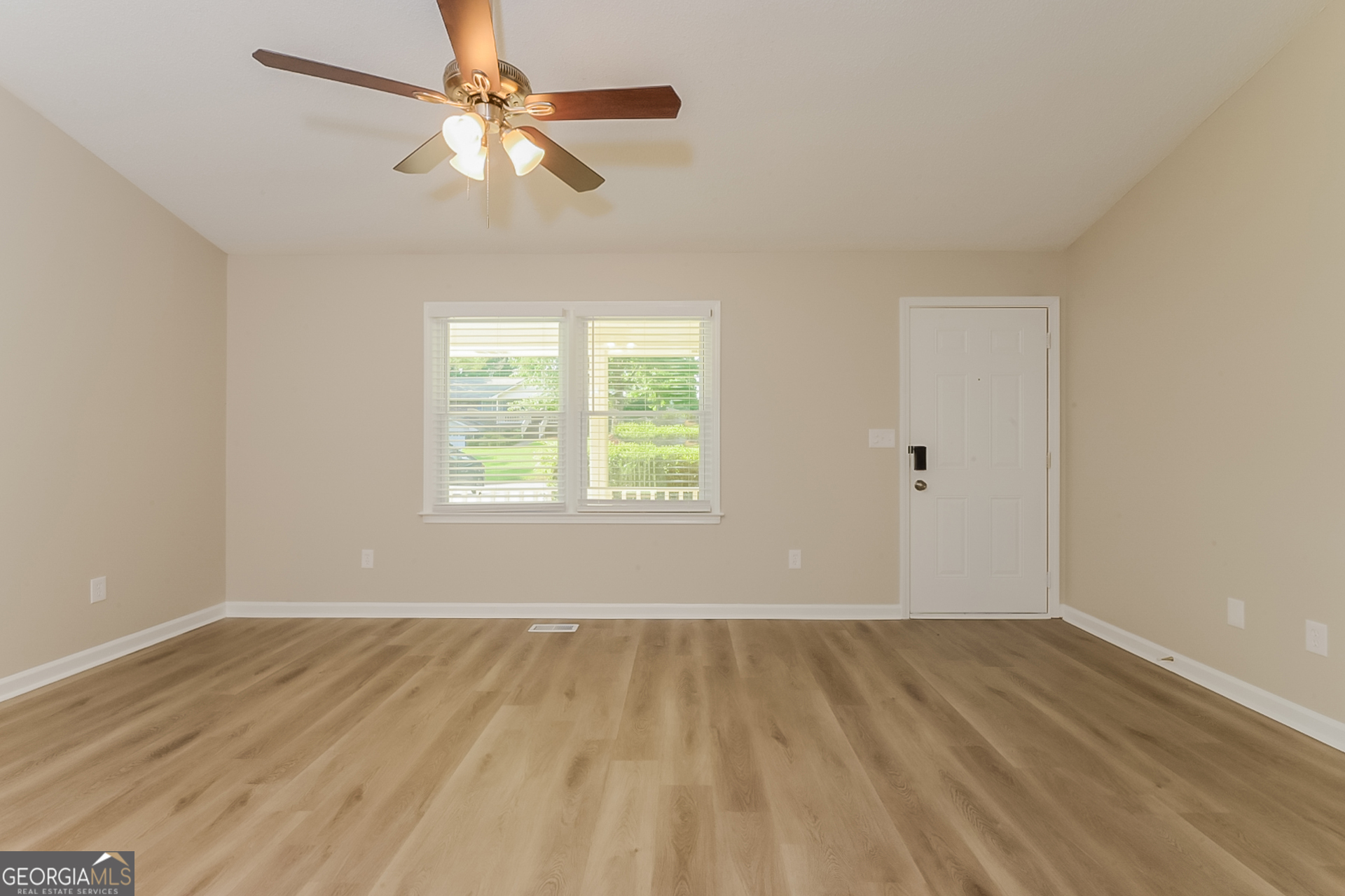 95 High Ridge Road Covington, GA 30014 - Photo 2 of 16 wooden floor in an empty room with a window