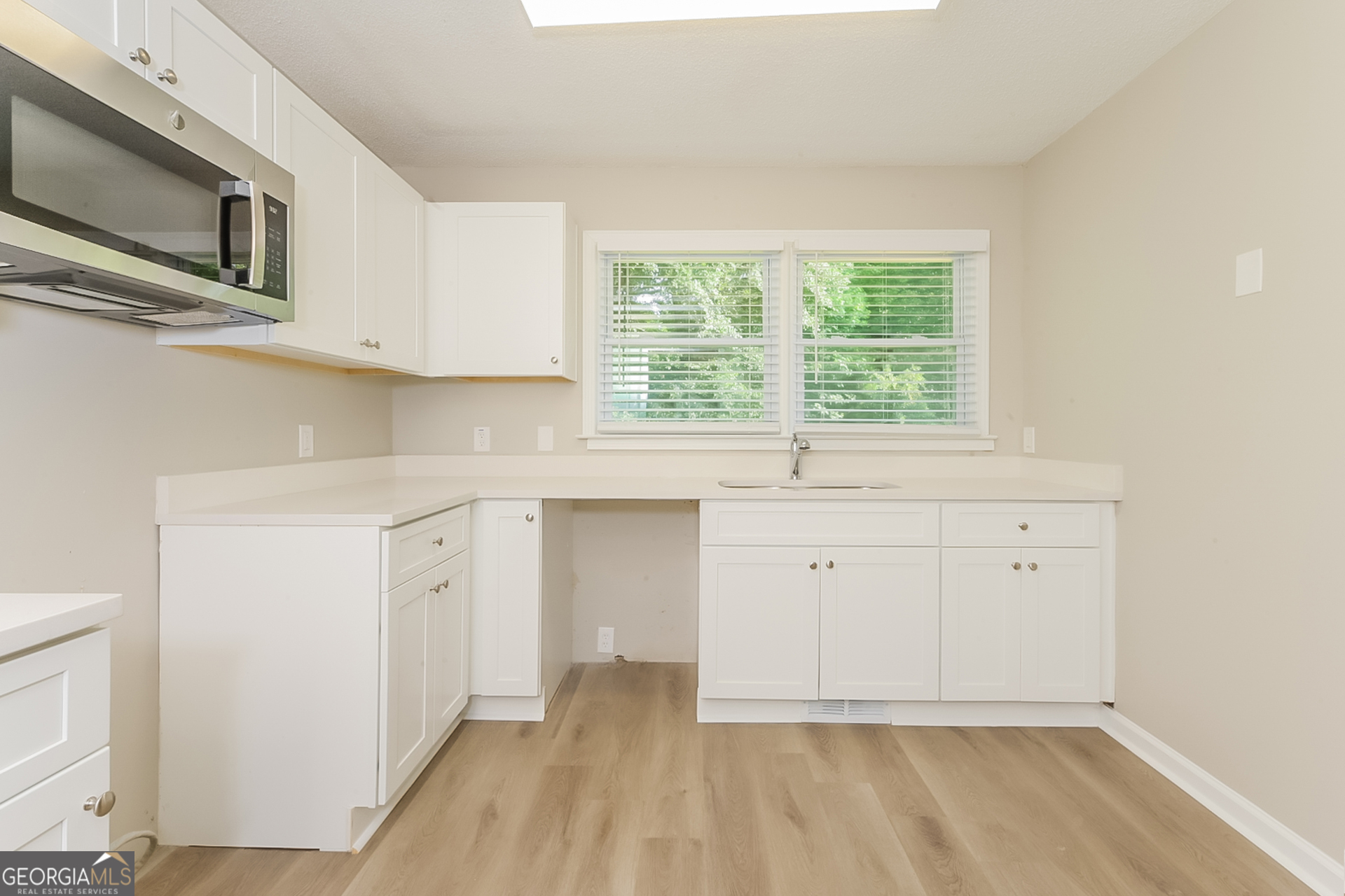 95 High Ridge Road Covington, GA 30014 - Photo 5 of 16 a view of an empty room with a sink and a window