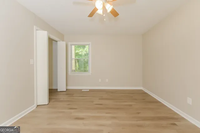 wooden floor in an empty room with a window