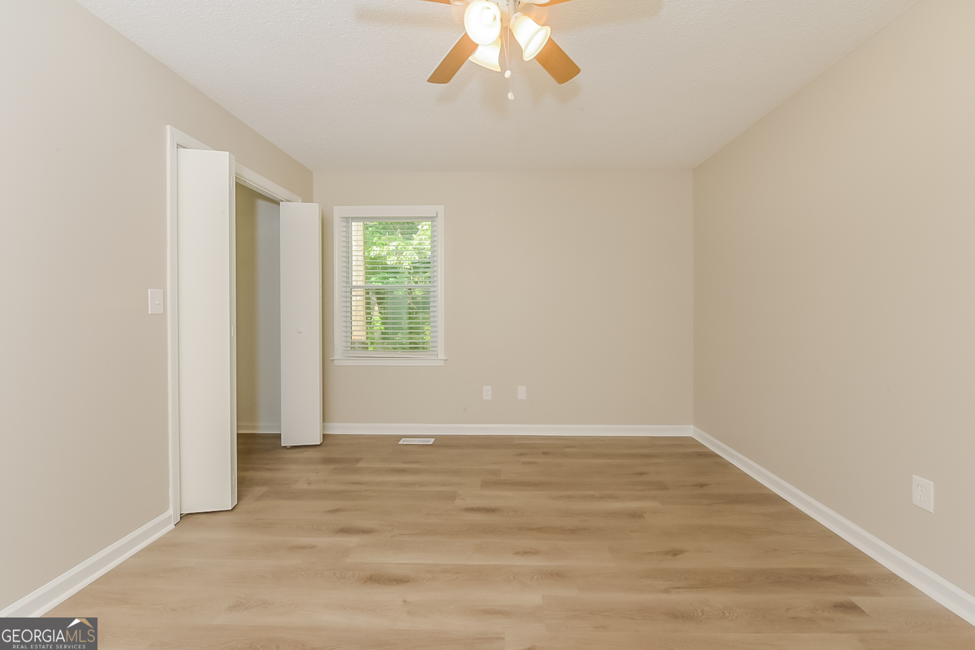 95 High Ridge Road Covington, GA 30014 - Photo 7 of 16 wooden floor in an empty room with a window