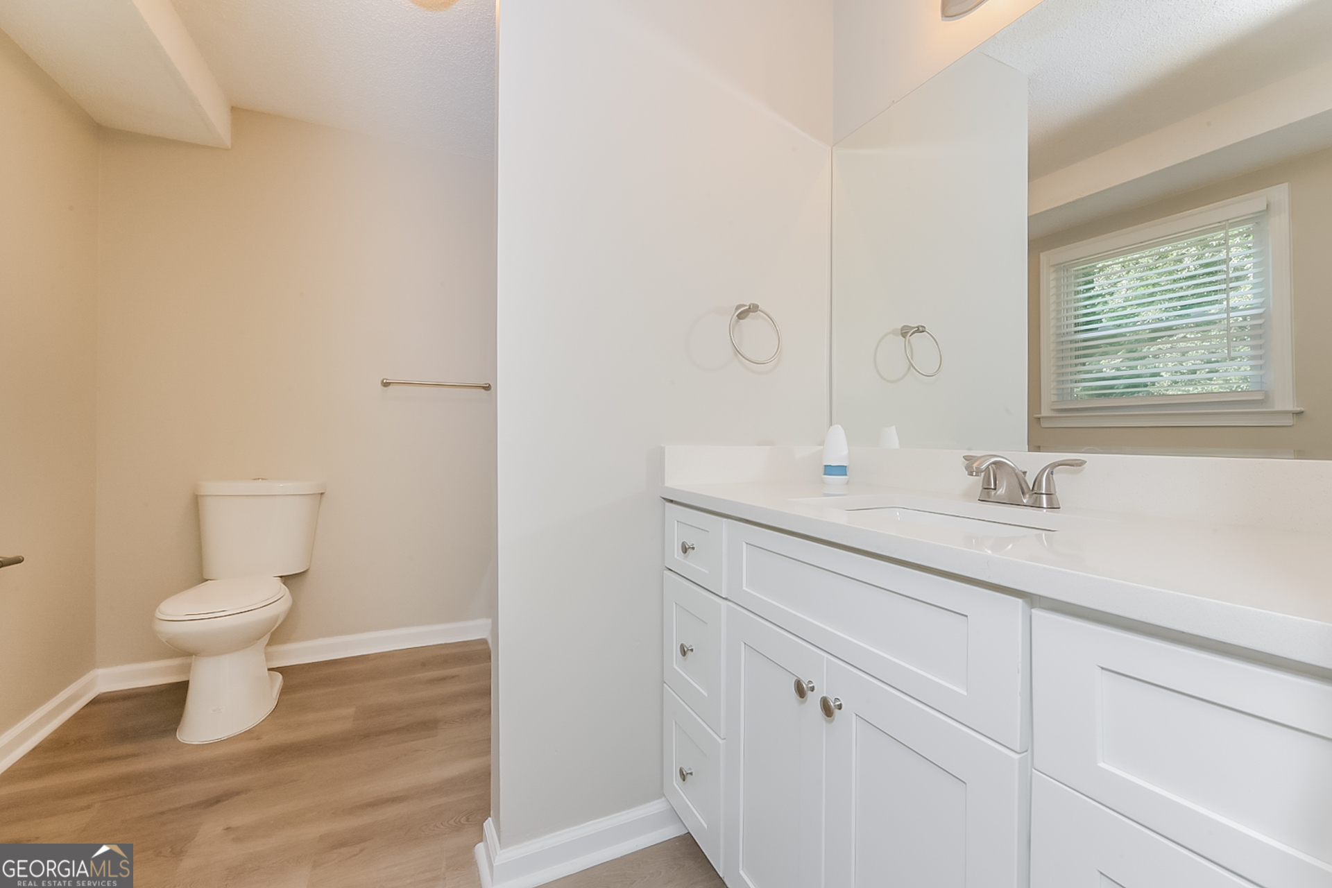 95 High Ridge Road Covington, GA 30014 - Photo 9 of 16 a bathroom with a sink a toilet and a window