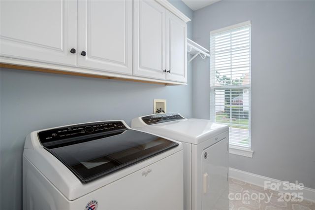 a kitchen that has a stove and a white cabinet