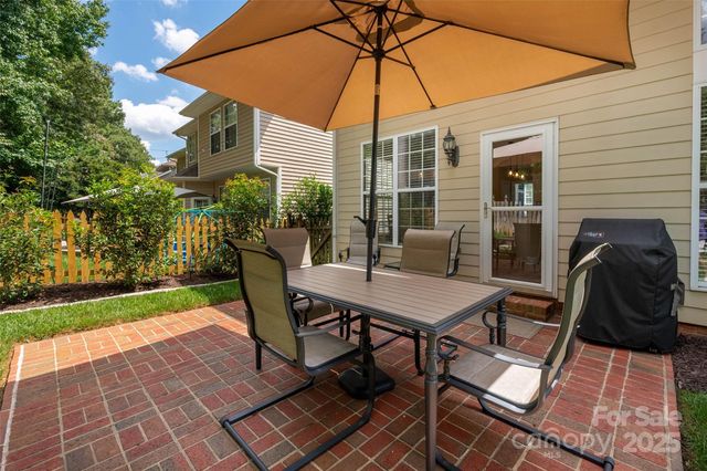 a table and chairs in patio of the house