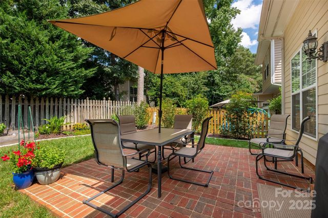 a view of a table and chairs under an umbrella