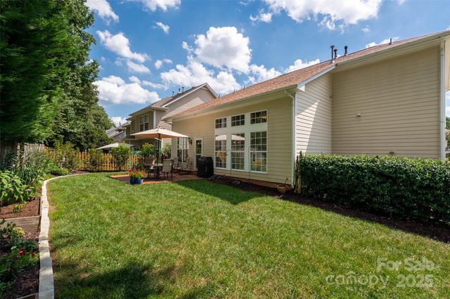 a view of a house with backyard sitting area and garden