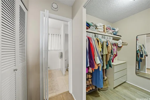 a view of walk in closet with clothes