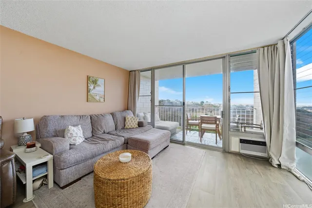 a living room with furniture and a floor to ceiling window