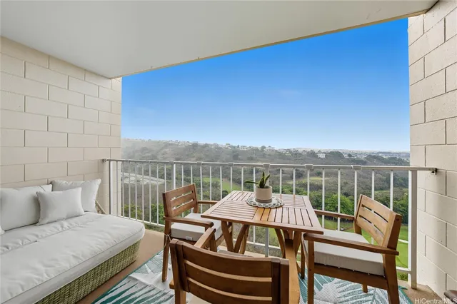a view of a balcony with two chairs and a table