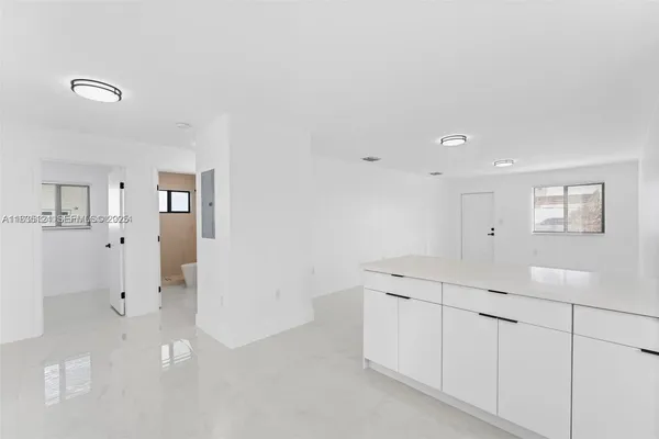 a view of a kitchen with white cabinets