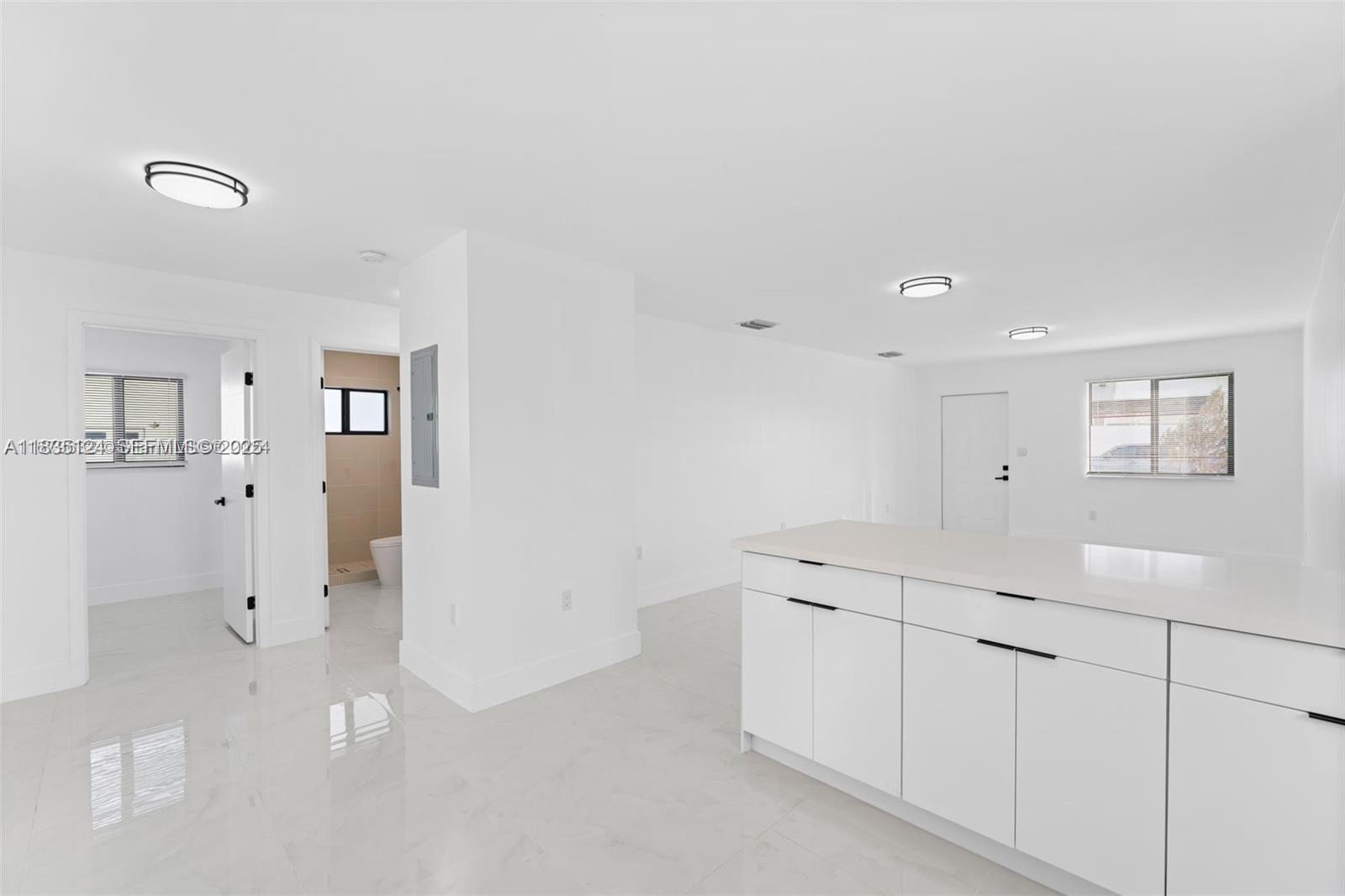 11997 Southwest 218th Street, Unit 1 Miami, FL 33170 - Photo 4 of 12 a view of a kitchen with white cabinets