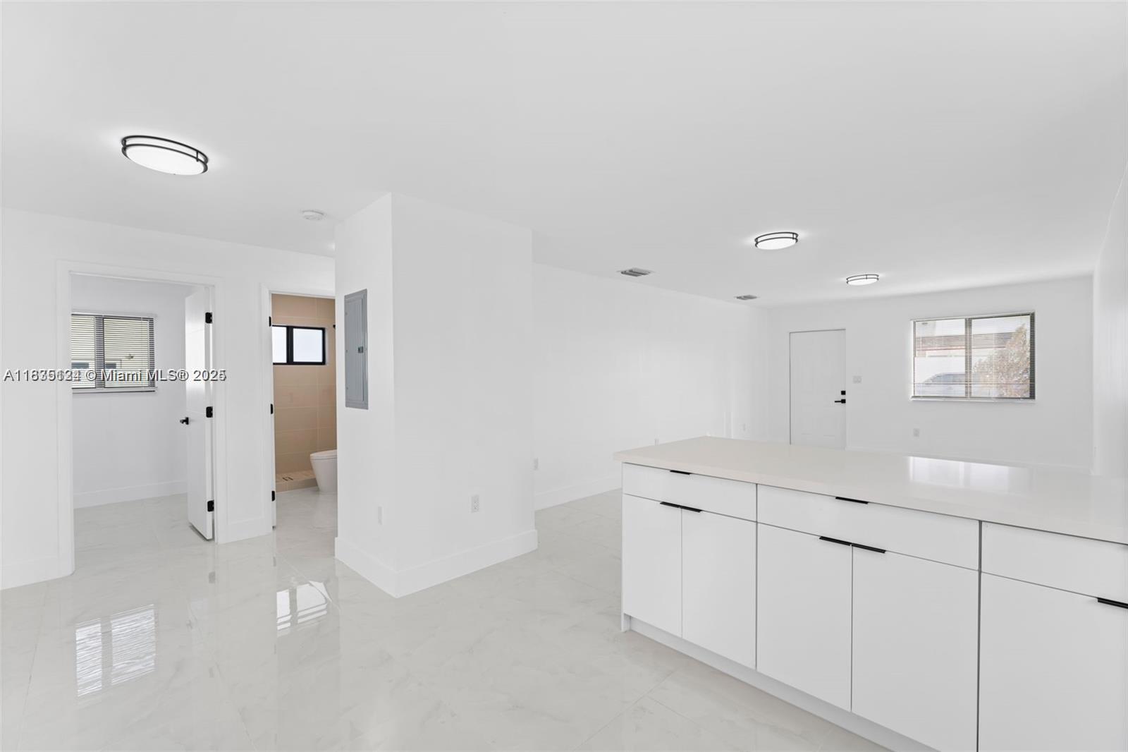 11997 Southwest 218th Street, Unit 1 Miami, FL 33170 - Photo 4 of 12 a view of a kitchen with white cabinets