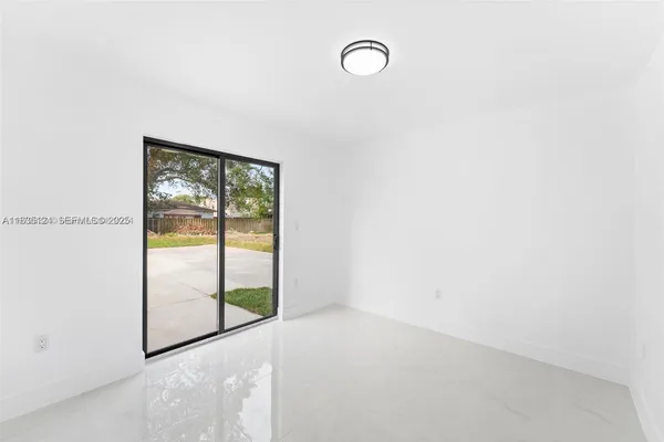 a view of an empty room with a window