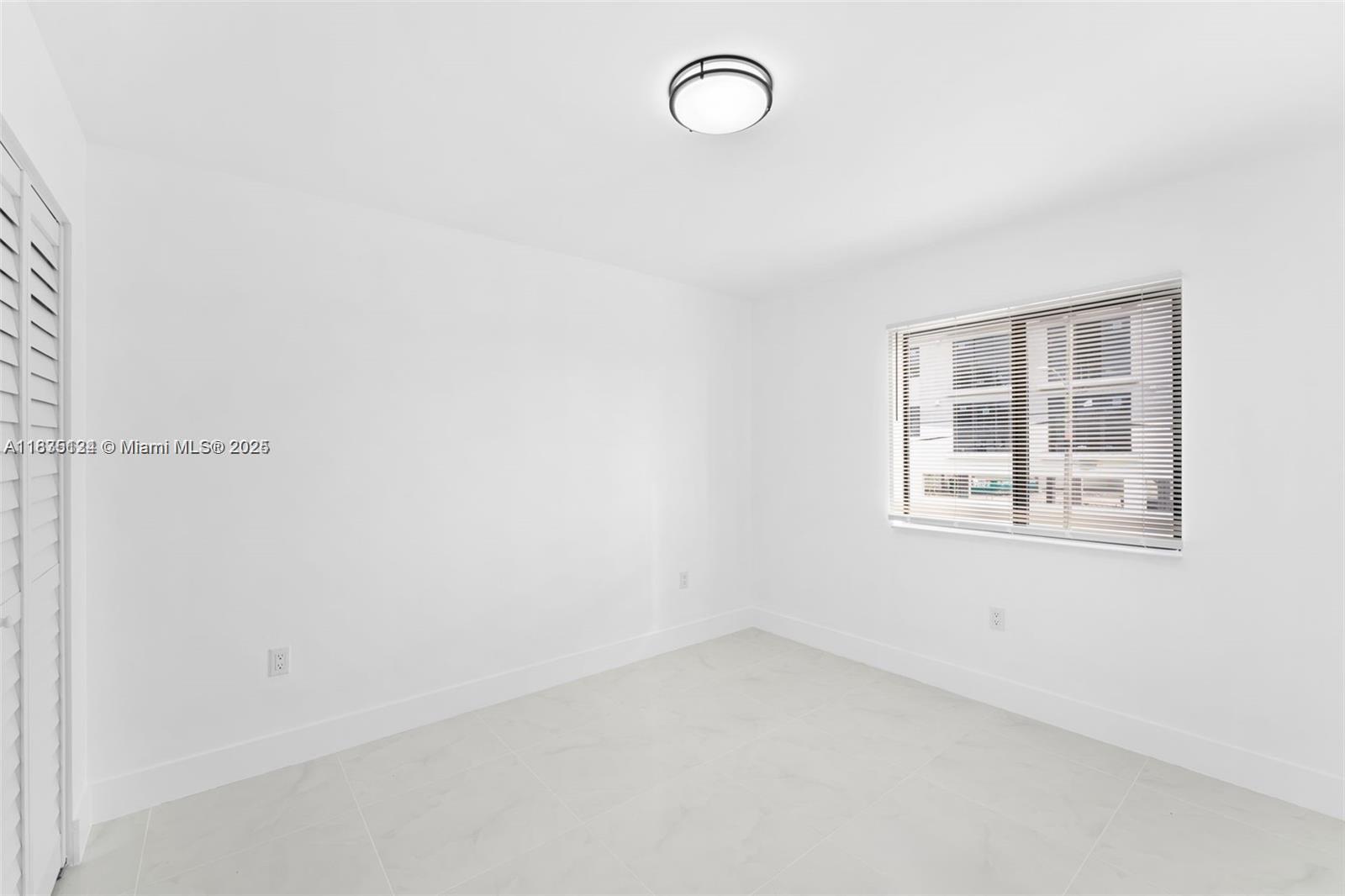 11997 Southwest 218th Street, Unit 1 Miami, FL 33170 - Photo 8 of 12 an empty room with windows