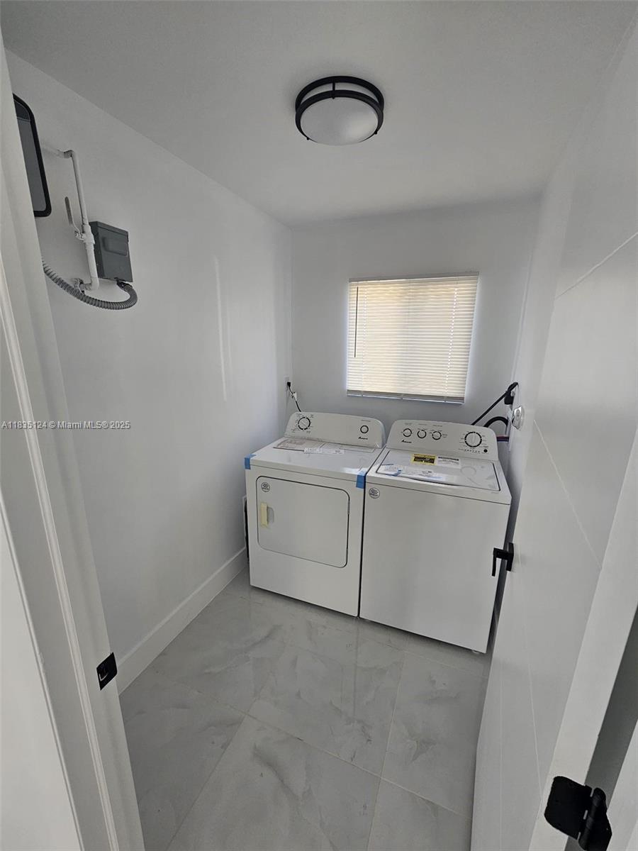 11997 Southwest 218th Street, Unit 1 Miami, FL 33170 - Photo 10 of 12 a utility room with dryer and washer