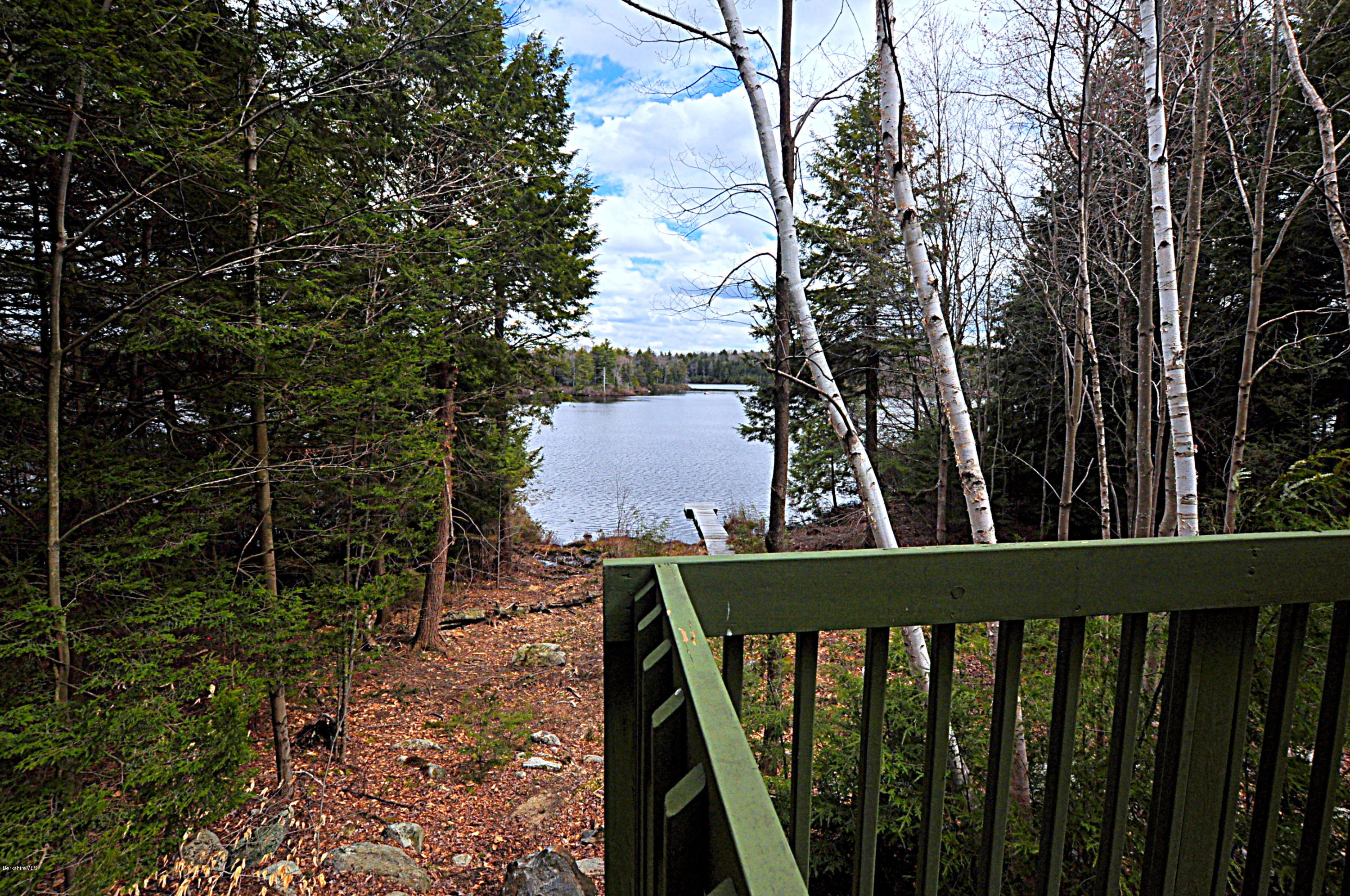 462 East Otis Road Tolland, MA 01034 - Photo 1 of 29 a view of a balcony with wooden floor and fence