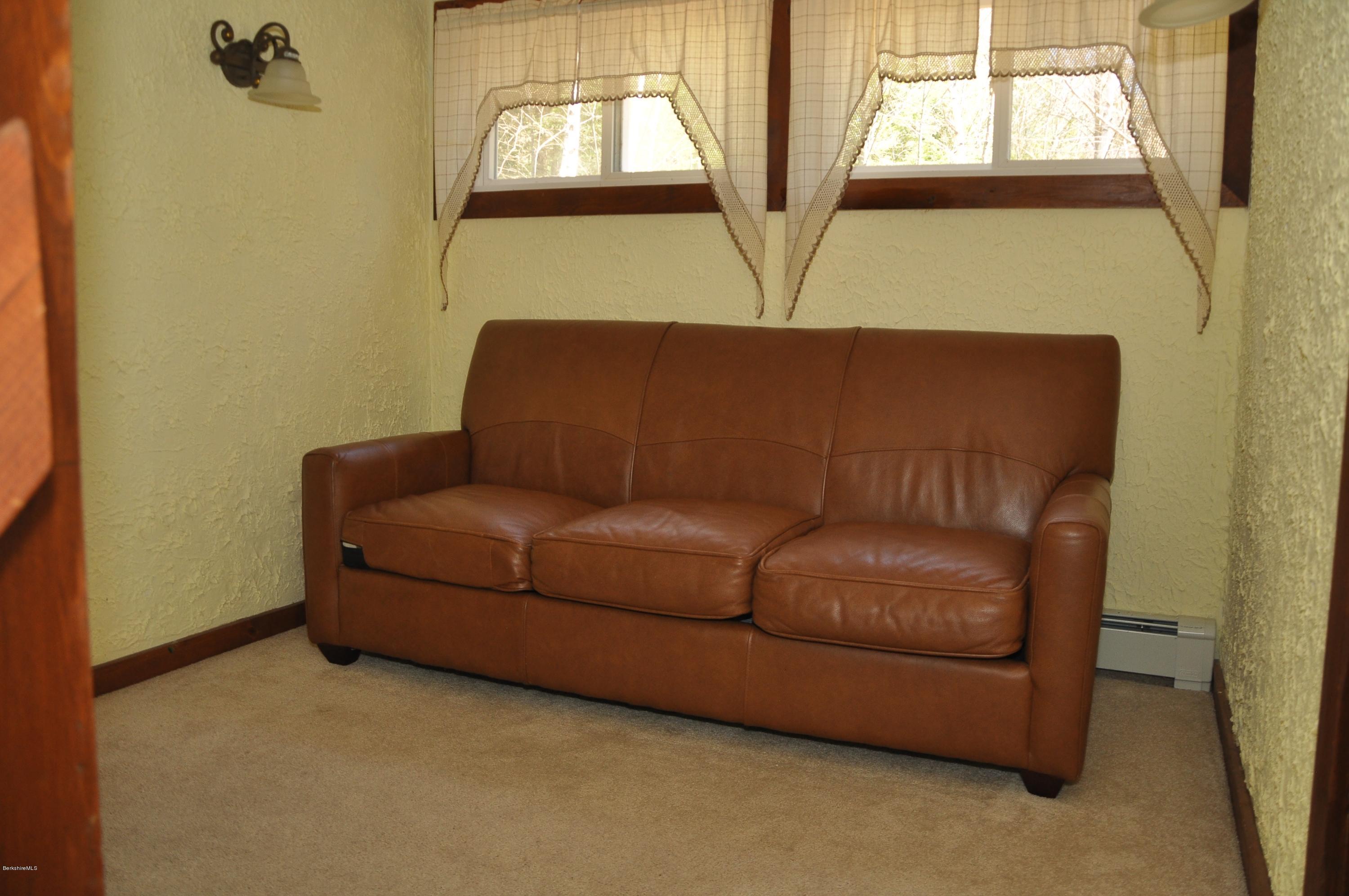 462 East Otis Road Tolland, MA 01034 - Photo 20 of 29 a blue couch sitting in front of a window