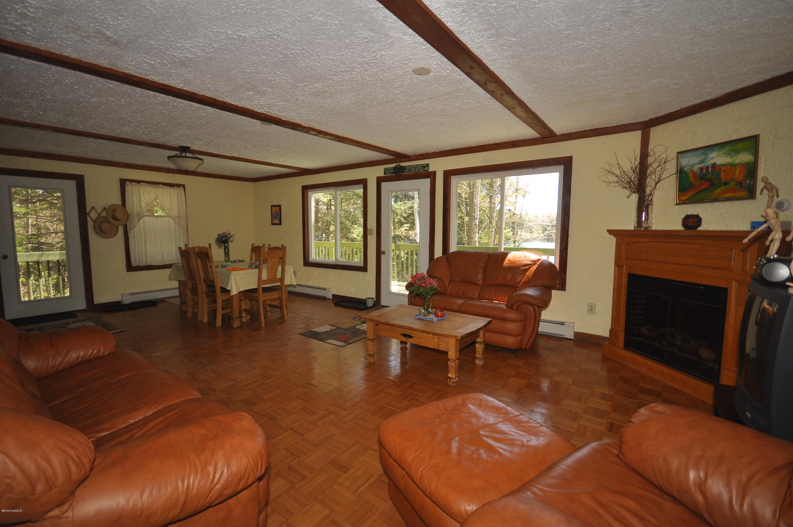 462 East Otis Road Tolland, MA 01034 - Photo 7 of 29 a living room with furniture a large window and a fireplace