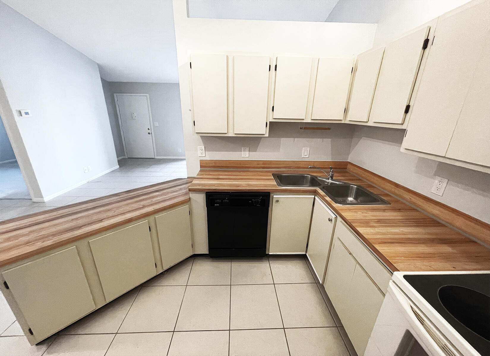 6572 Chasewood Drive, Unit E Jupiter, FL 33458 - Photo 12 of 23 a kitchen with a stove sink and cabinets