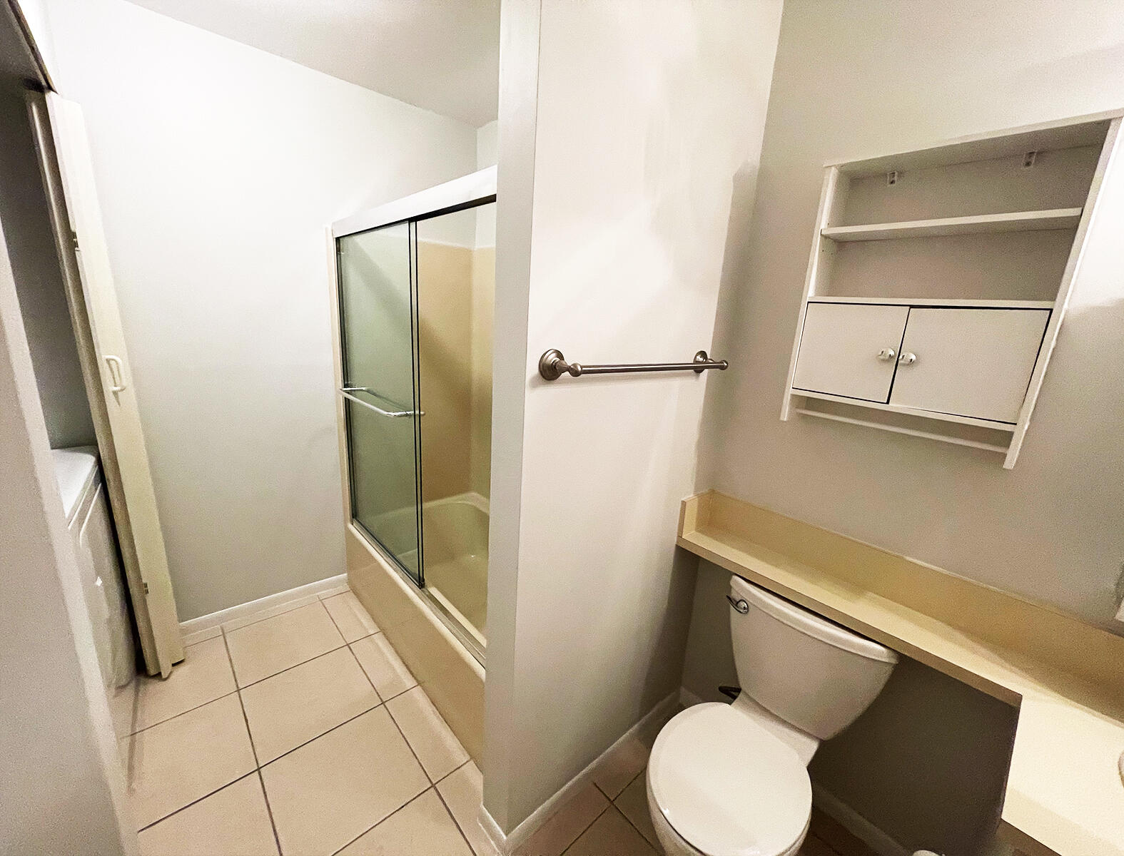 6572 Chasewood Drive, Unit E Jupiter, FL 33458 - Photo 18 of 23 a bathroom with a toilet and a shower