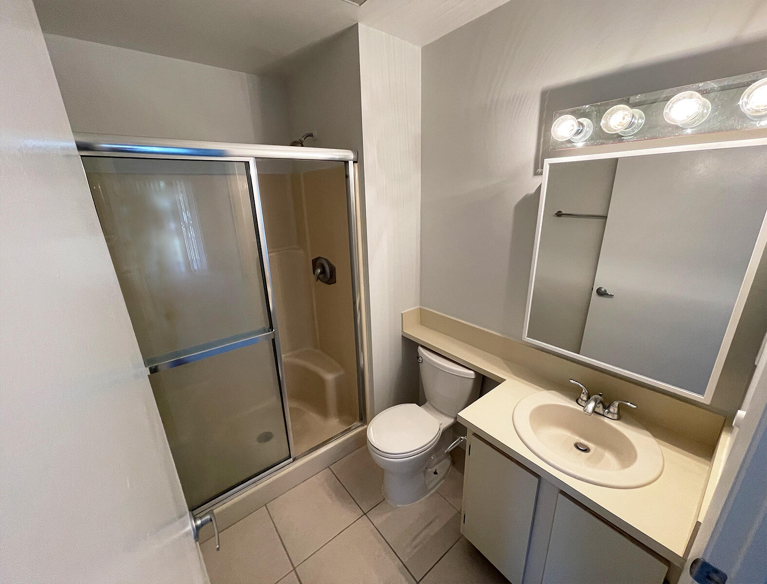 6572 Chasewood Drive, Unit E Jupiter, FL 33458 - Photo 6 of 23 a bathroom with a sink a toilet a mirror and vanity