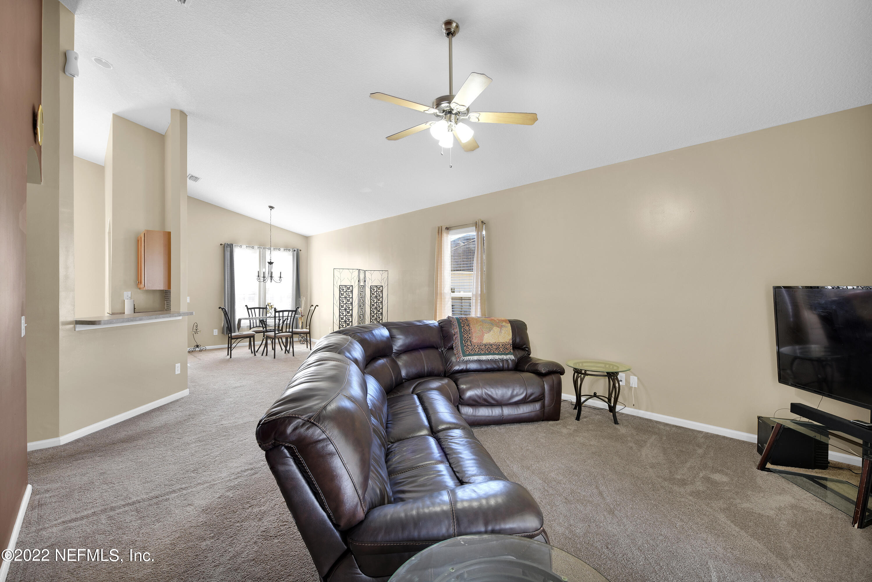 11941 Crooked River Road Jacksonville, FL 32219 - Photo 11 of 28 a living room with furniture and a flat screen tv